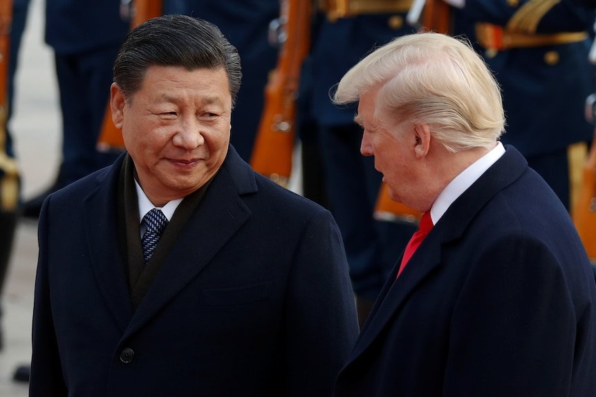 Xi Jinping smiles over his shoulder as he looks at Donald Trump.uring a