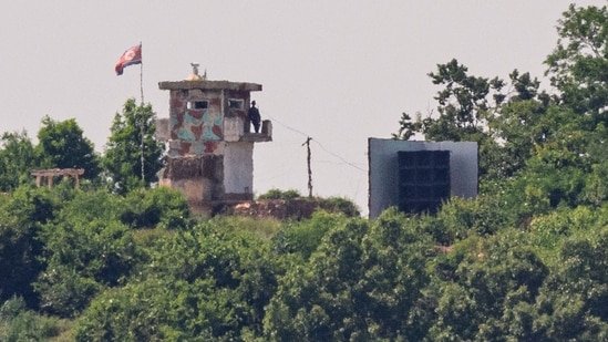 This photo shows a North Korean soldier standing guard in a watch tower next to a giant loudspeaker (R), near the Demilitarized Zone (DMZ) dividing the two Koreas in Paju on June 12, 2025.(AFP)