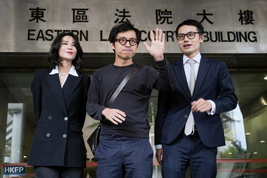 Hong Kong influencer Joseph Lam (centre) leaves the Eastern Magistrates' Court after facing criminal charges in connection with cryptocurrency platform JPEX on November 6, 2025. Photo: Kyle Lam/HKFP.