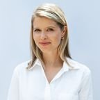 Laura Hensley smiling at the camera in a white shirt