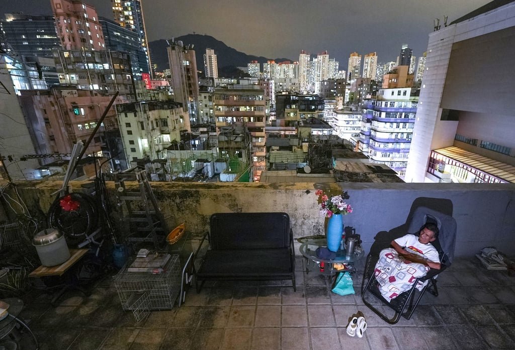 Chan relaxes outside his rooftop home in Sham Shui Po. Photo: Eugene Lee